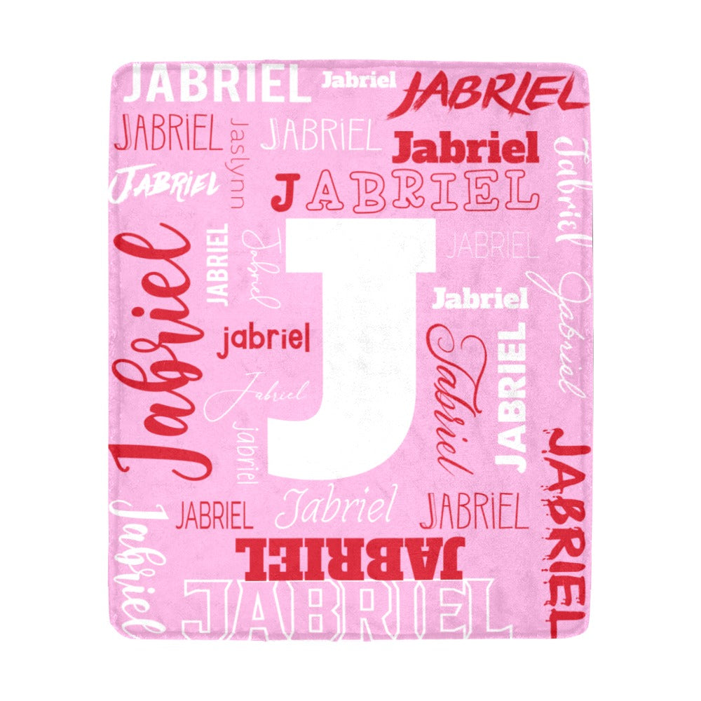 Pink personalized name and initial microfleece blanket with the name Jabriel and letter J